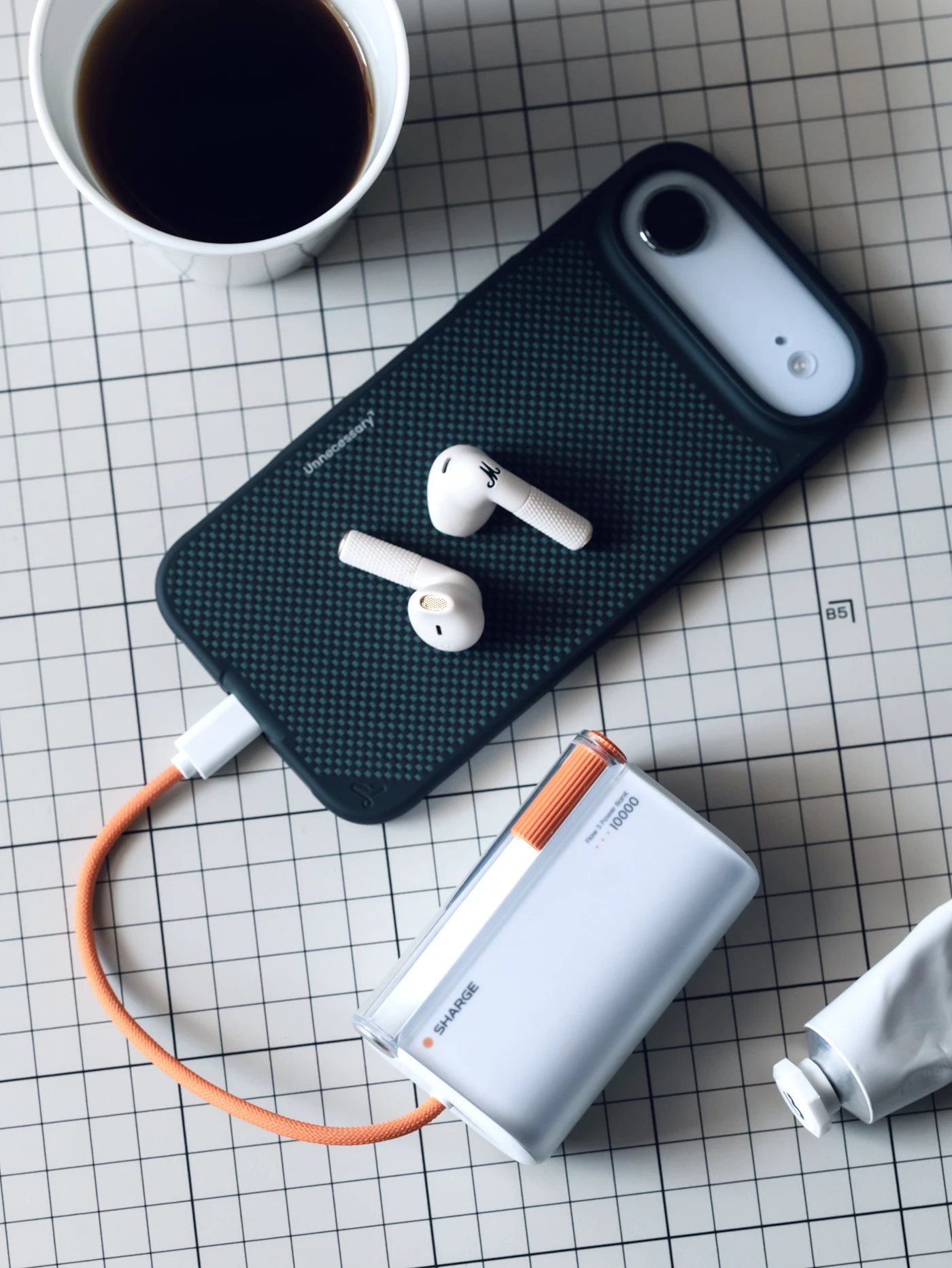 Smartphone charging with wireless earbuds and coffee