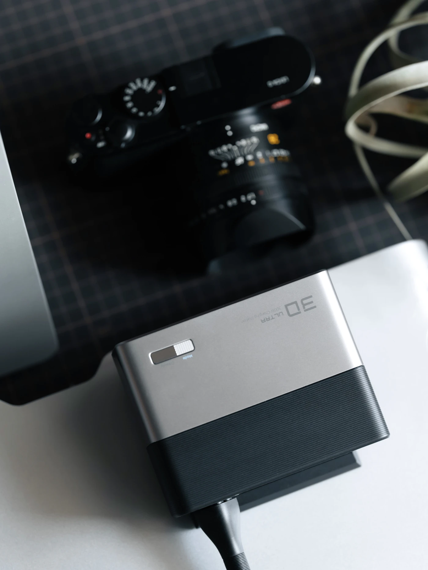 A portable external storage drive beside a laptop